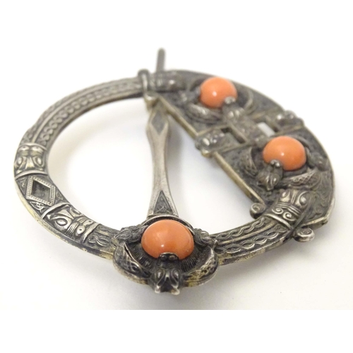 704A - A Victorian Irish / Celtic white metal tara brooch set with three coral cabochon. Marked West & Son,... 