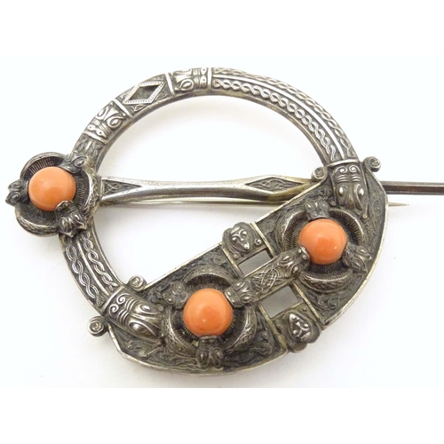 704A - A Victorian Irish / Celtic white metal tara brooch set with three coral cabochon. Marked West & Son,... 