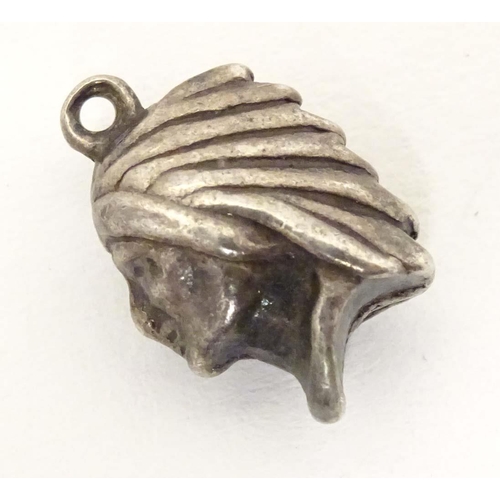 705 - A white metal pendant charm formed as the head of a Native American Indian. Approx. 1/2