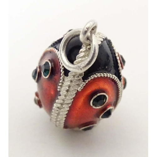 706 - A white metal pendant charm of egg form with stylised ladybird / ladybug detail with enamel detail. ... 