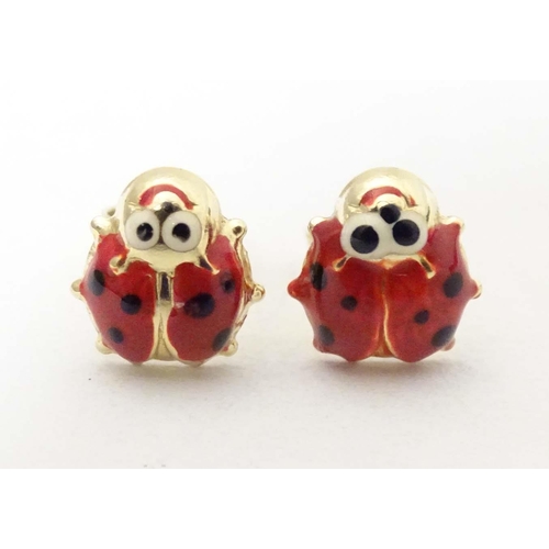 707 - A pair of 14ct gold stud earrings formed as ladybirds / ladybugs with enamel decoration. Approx. 1/4... 