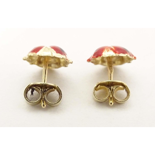 707 - A pair of 14ct gold stud earrings formed as ladybirds / ladybugs with enamel decoration. Approx. 1/4... 