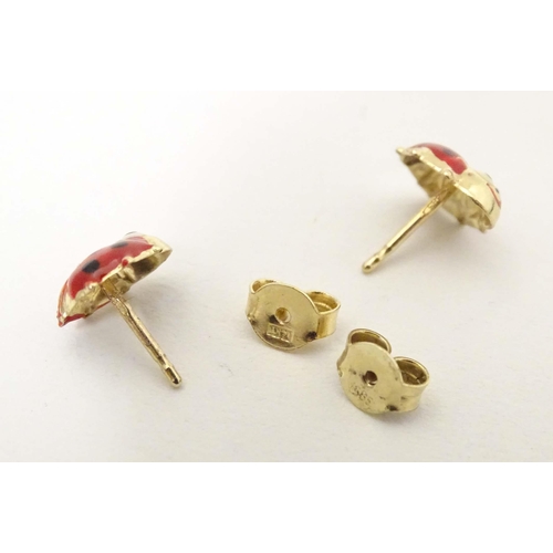 707 - A pair of 14ct gold stud earrings formed as ladybirds / ladybugs with enamel decoration. Approx. 1/4... 