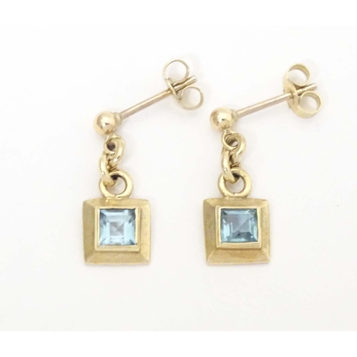 710 - A pair of 9ct gold drop earrings set with aquamarine. Approx. 1/2