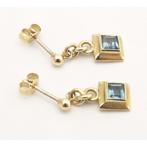 710 - A pair of 9ct gold drop earrings set with aquamarine. Approx. 1/2