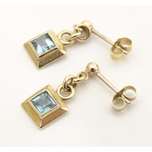 710 - A pair of 9ct gold drop earrings set with aquamarine. Approx. 1/2