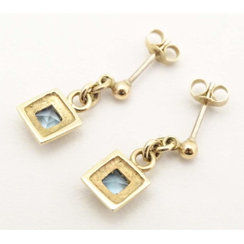 710 - A pair of 9ct gold drop earrings set with aquamarine. Approx. 1/2