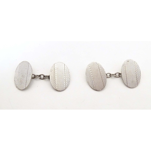 712 - Silver cufflinks with engine turned decoration. Cased.