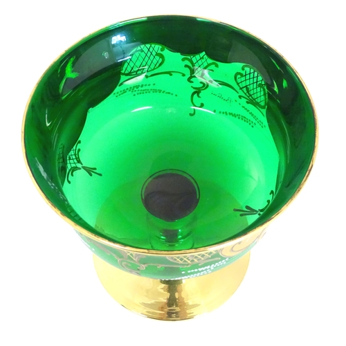 284 - A Bohemian green glass pedestal bowl with gilt and enamel floral detail. Approx. 7