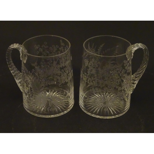 285 - Two 19thC glass tankards with twist handles and engraved foliate decoration. One titled 'Mary', the ... 