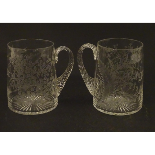 285 - Two 19thC glass tankards with twist handles and engraved foliate decoration. One titled 'Mary', the ... 