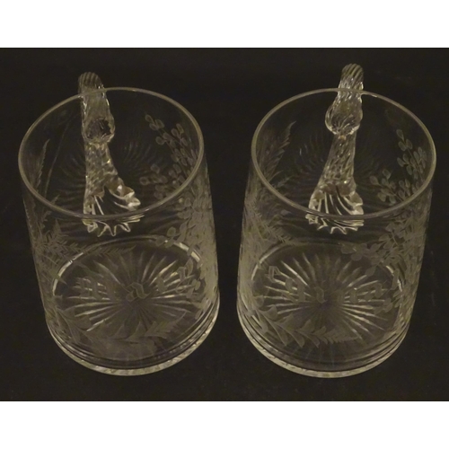 285 - Two 19thC glass tankards with twist handles and engraved foliate decoration. One titled 'Mary', the ... 