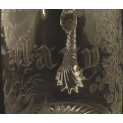 285 - Two 19thC glass tankards with twist handles and engraved foliate decoration. One titled 'Mary', the ... 