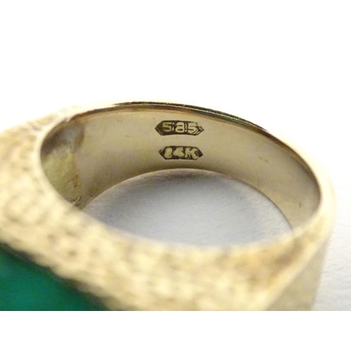 558 - A 14ct gold ring set with jade cabochon. Ring size approx H 1/2.