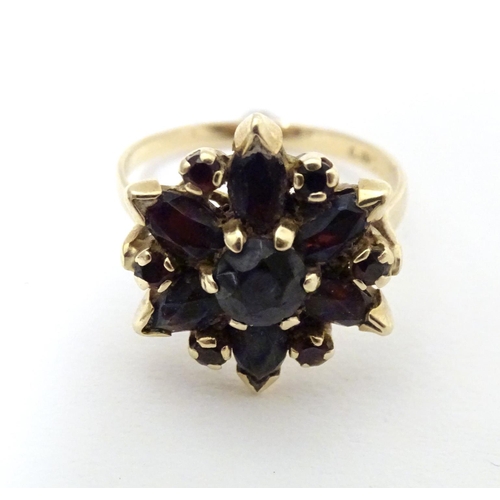 560 - A 9ct gold ring set with garnets. Ring size approx R