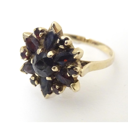 560 - A 9ct gold ring set with garnets. Ring size approx R