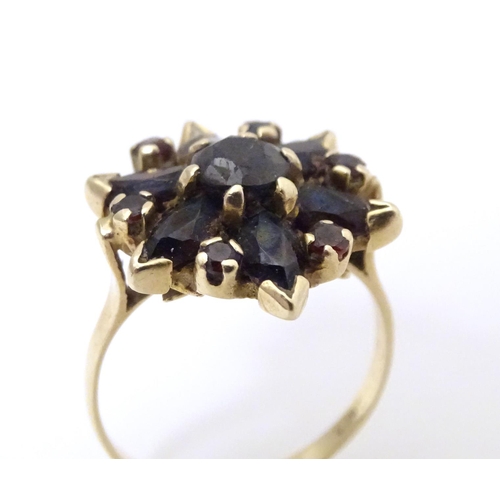 560 - A 9ct gold ring set with garnets. Ring size approx R