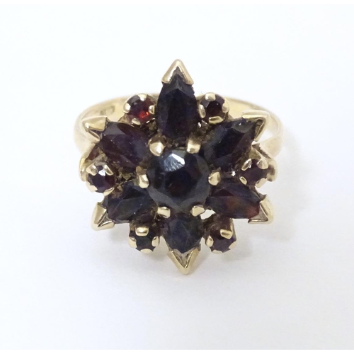 560 - A 9ct gold ring set with garnets. Ring size approx R