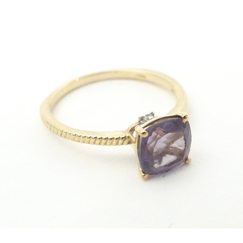 565 - A 9ct gold ring set with blueberry quartz to centre. Ring size approx R