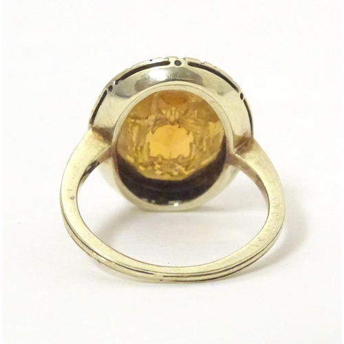 567 - A late 19th / early 20thC yellow metal ring with engraved citrine seal to top depicting monogram. Ri... 