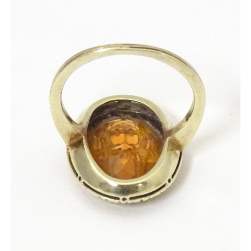 567 - A late 19th / early 20thC yellow metal ring with engraved citrine seal to top depicting monogram. Ri... 