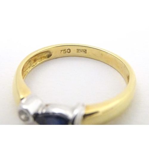 568 - An 18ct gold ring set with sapphire and diamond. Ring size approx. L