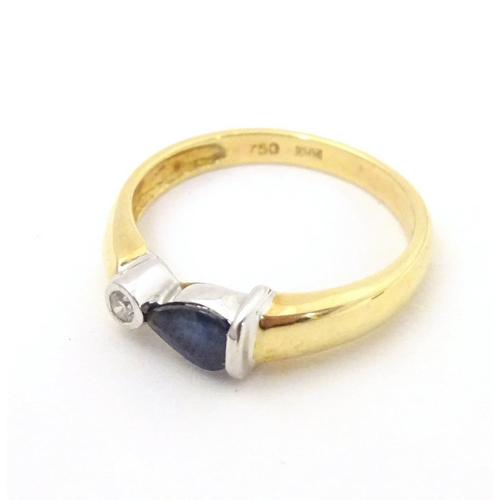 568 - An 18ct gold ring set with sapphire and diamond. Ring size approx. L