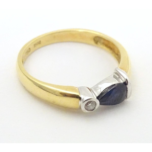 568 - An 18ct gold ring set with sapphire and diamond. Ring size approx. L