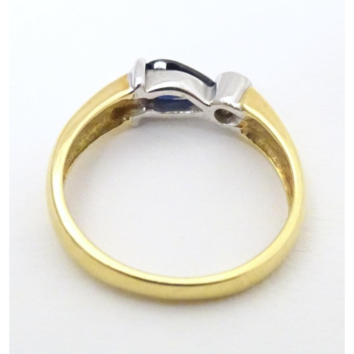 568 - An 18ct gold ring set with sapphire and diamond. Ring size approx. L