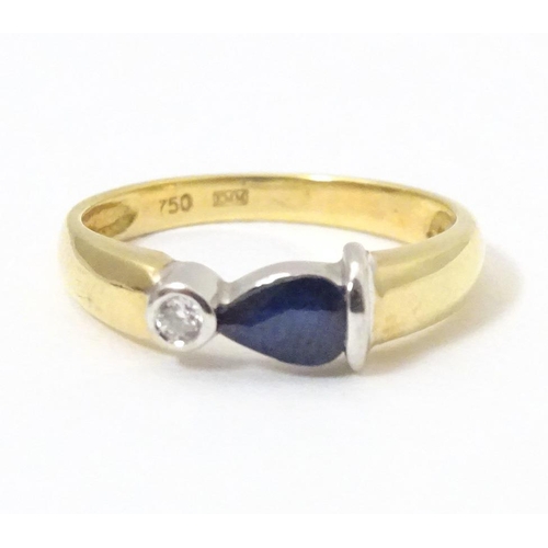 568 - An 18ct gold ring set with sapphire and diamond. Ring size approx. L