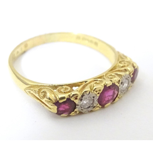 570 - An 18ct gold ring set with diamonds and rubies in a linear setting. Ring size approx. U 1/2