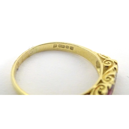 570 - An 18ct gold ring set with diamonds and rubies in a linear setting. Ring size approx. U 1/2