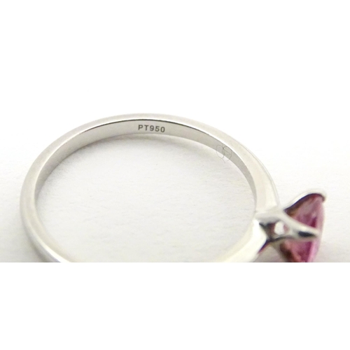 573 - A platinum ring set with pink sapphire solitaire. Ring size approx. O