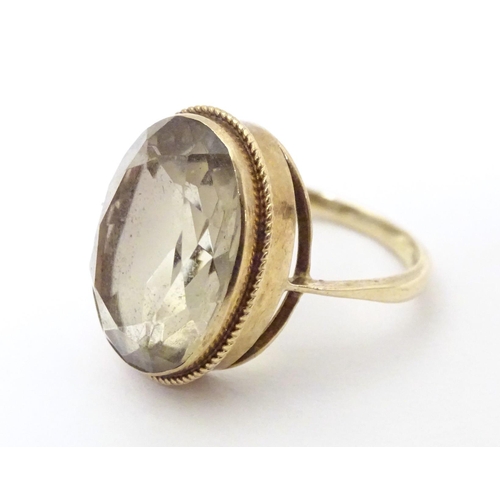 574 - A 9ct gold dress ring set with citrine. Ring size approx. N