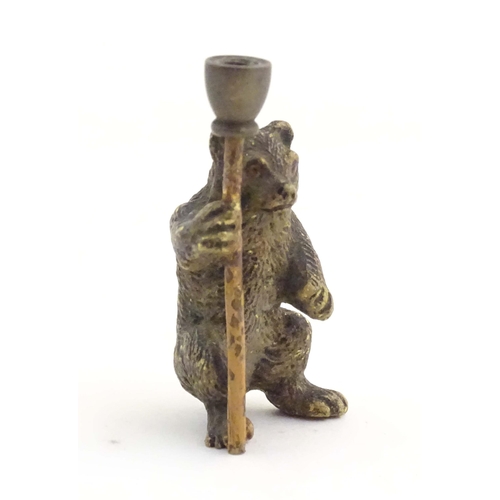 1013 - A novelty cold painted bronze model of a bear with a staff. Approx. 1 3/4