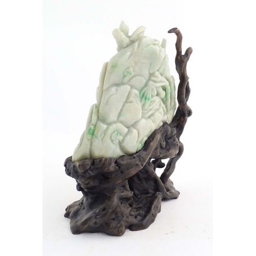 1027 - A Chinese light jade coloured hardstone 'boulder' carving depicting birds feeding chicks in a nest a... 