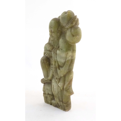 1028 - A Chinese carved soapstone figure depicting the Chinese God of Longevity, Shou Lao holding the peach... 