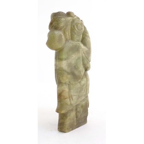 1028 - A Chinese carved soapstone figure depicting the Chinese God of Longevity, Shou Lao holding the peach... 