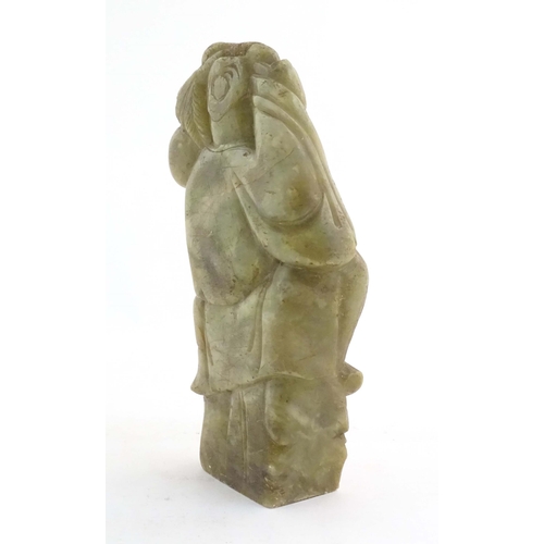 1028 - A Chinese carved soapstone figure depicting the Chinese God of Longevity, Shou Lao holding the peach... 