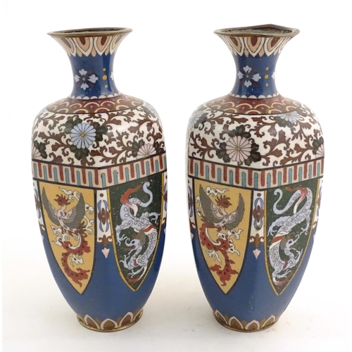 1031 - A pair of Oriental cloisonne vases decorated with panels of dragons and phoenix birds, the shoulders... 