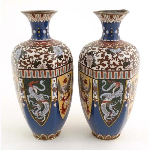 1031 - A pair of Oriental cloisonne vases decorated with panels of dragons and phoenix birds, the shoulders... 