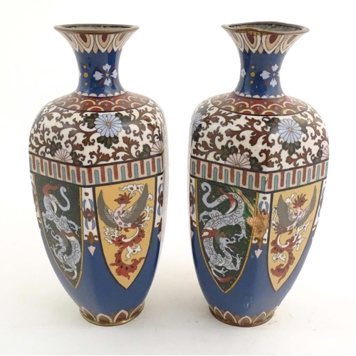 1031 - A pair of Oriental cloisonne vases decorated with panels of dragons and phoenix birds, the shoulders... 