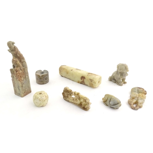 1036 - A quantity of assorted Oriental carved soapstone items to include a hand seal surmounted by two figu... 