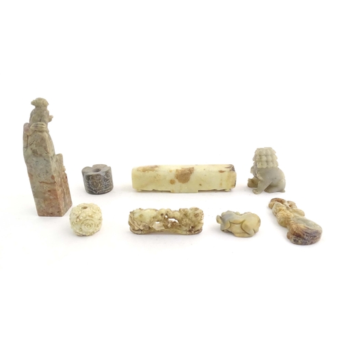 1036 - A quantity of assorted Oriental carved soapstone items to include a hand seal surmounted by two figu... 