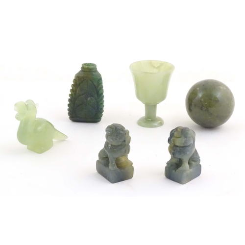 1042 - A quantity of Oriental jade coloured hardstone carvings to include two miniature foo dogs, a miniatu... 