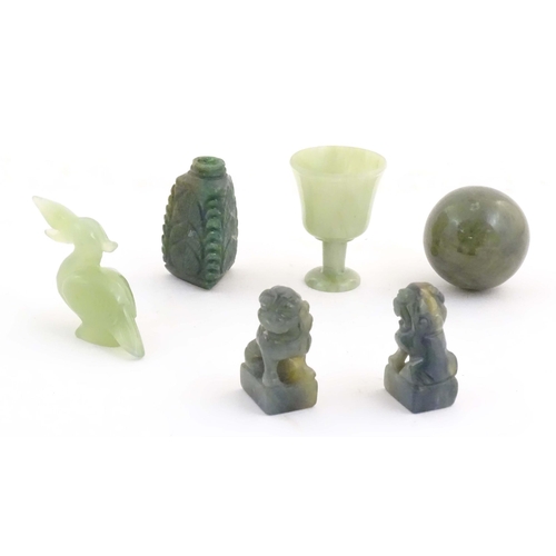 1042 - A quantity of Oriental jade coloured hardstone carvings to include two miniature foo dogs, a miniatu... 