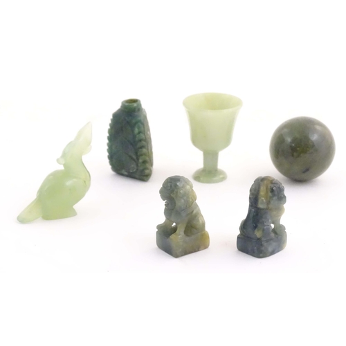 1042 - A quantity of Oriental jade coloured hardstone carvings to include two miniature foo dogs, a miniatu... 