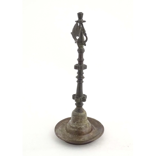 1050 - An Indian / Deccan cast temple style oil lamp with turned column surmounted by a Hamsa bird. Approx.... 