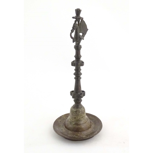 1050 - An Indian / Deccan cast temple style oil lamp with turned column surmounted by a Hamsa bird. Approx.... 