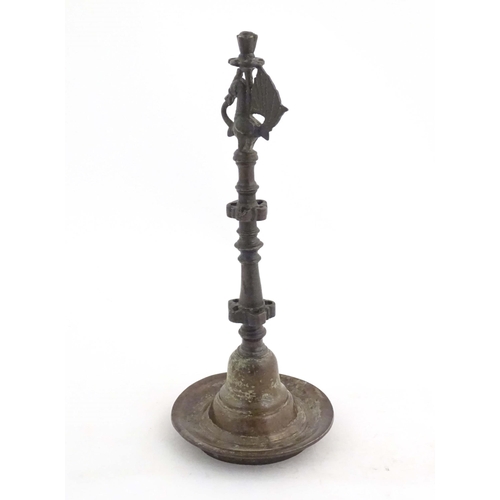 1050 - An Indian / Deccan cast temple style oil lamp with turned column surmounted by a Hamsa bird. Approx.... 